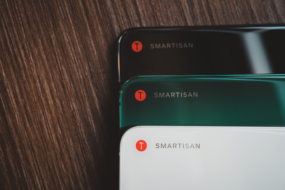close-up photography of black, green, and white smartphnes