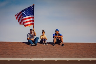 men and woman sitting on roof top