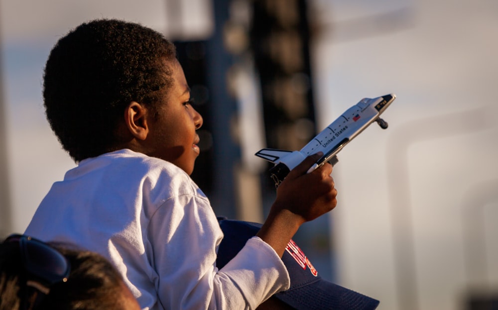 boy holding space shuttle