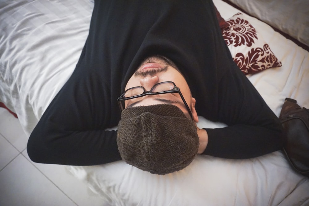 black framed eyeglasses on persons lap