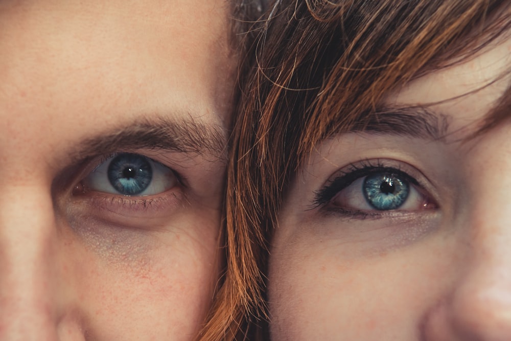 closeup photo of two person blue eyes