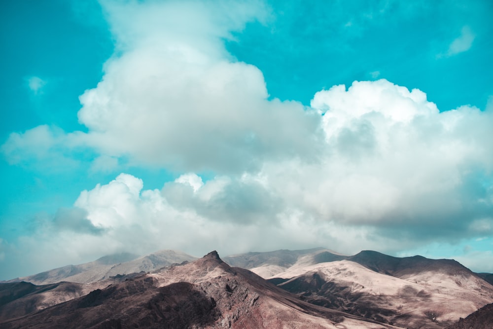 aerial photography of mountain under white and blue sky during daytime