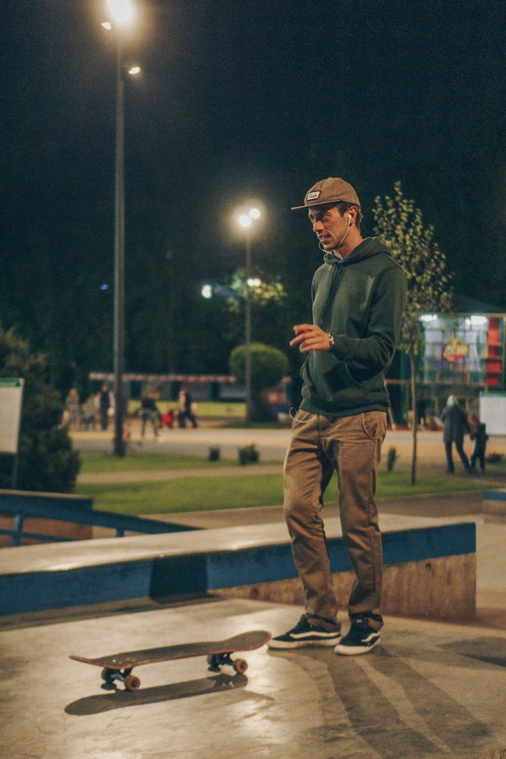 shallow focus photo of man in green pullover hoodie