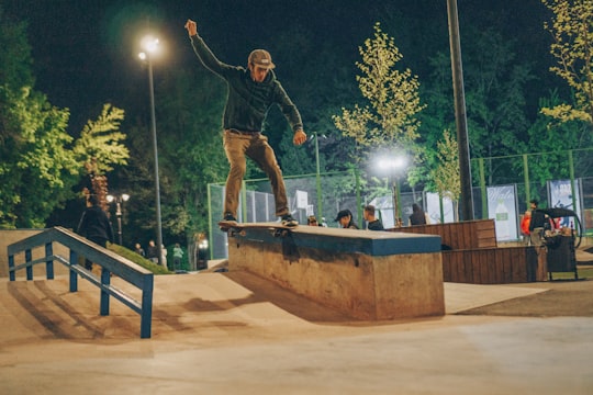 time lapse photography of man doing skateboard tricks in Almaty Kazakhstan