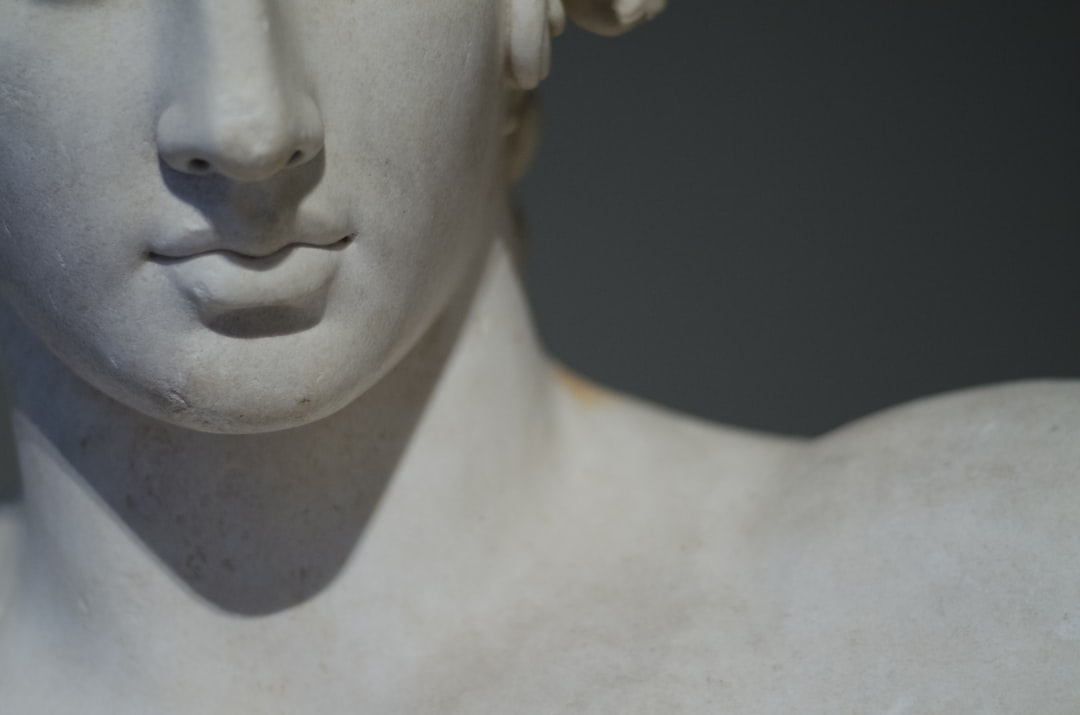 white concrete statue of man, greek statue