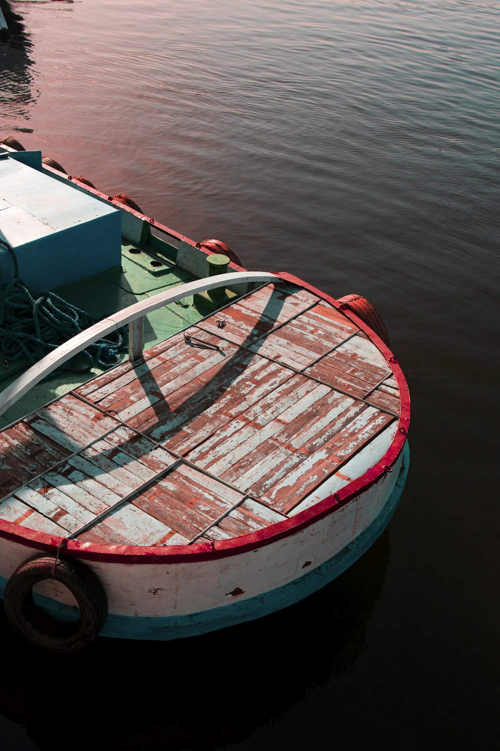red and white boat on body of water