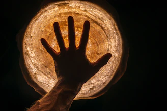 Close-up of a hand hovering over a glowing subject card with subtle shadow and rounded corners.