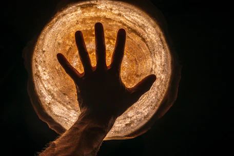 Close-up of a hand hovering over a glowing subject card with subtle shadow and rounded corners.