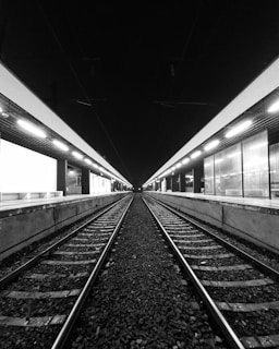 grayscale photo of train rails