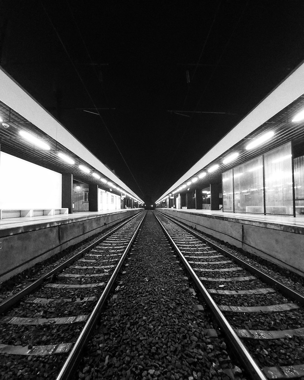 grayscale photo of train rails