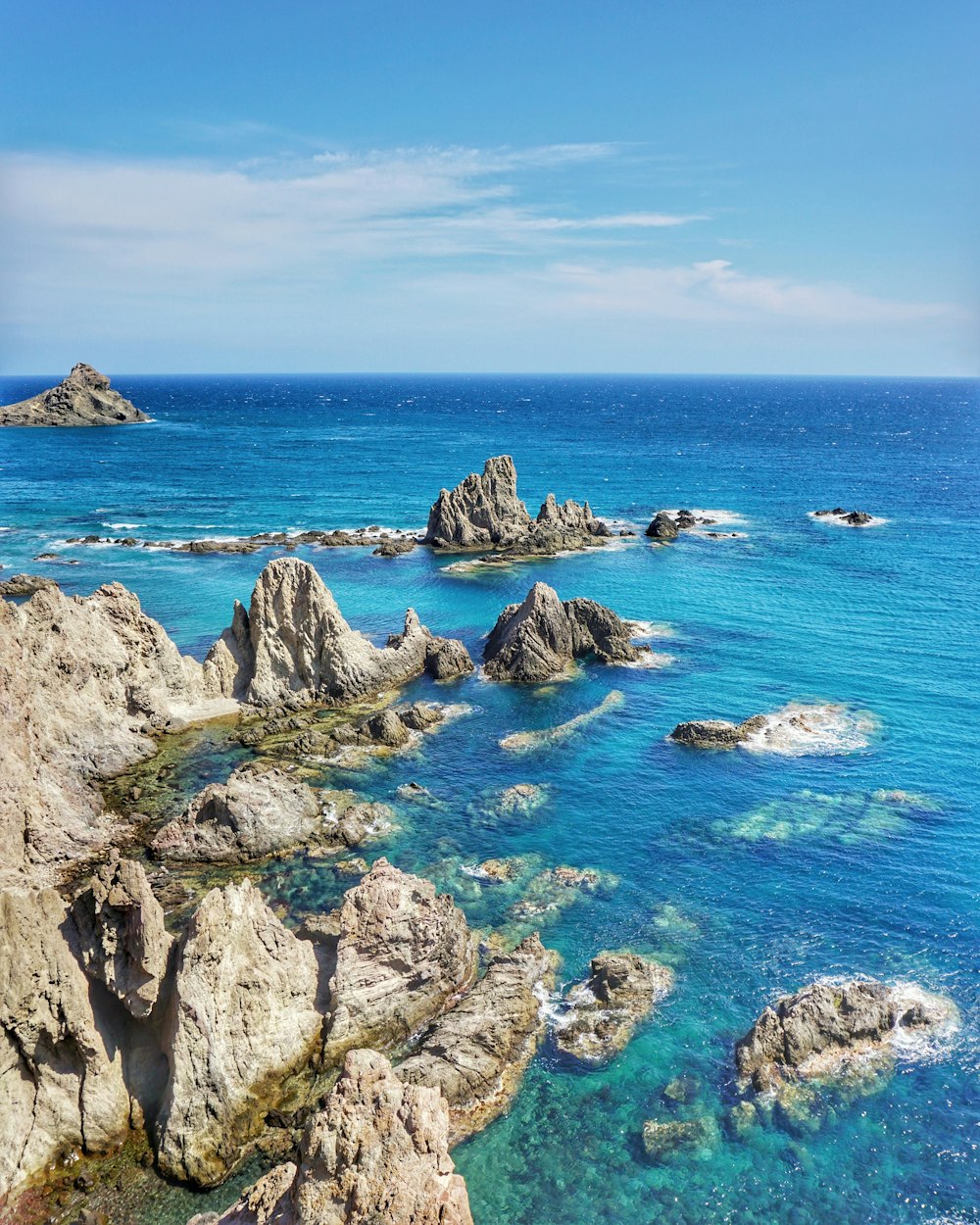 aerial photo of boulders on ocean