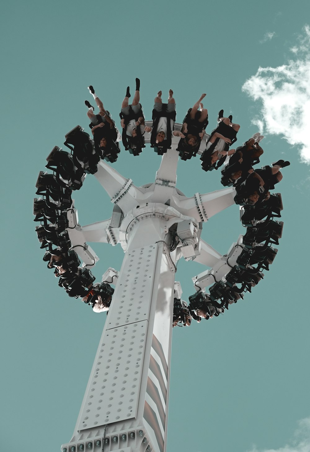 low-angle photography of people riding a drop-down amusement tower