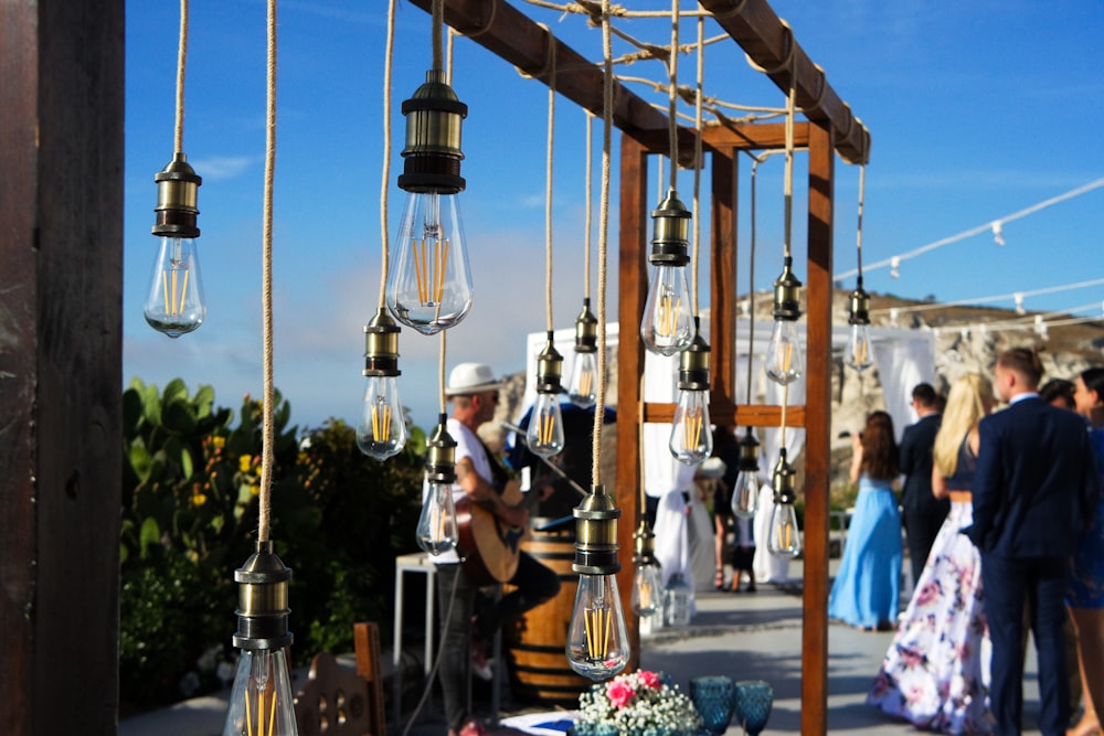 people walking by near hanging bulb ornaments