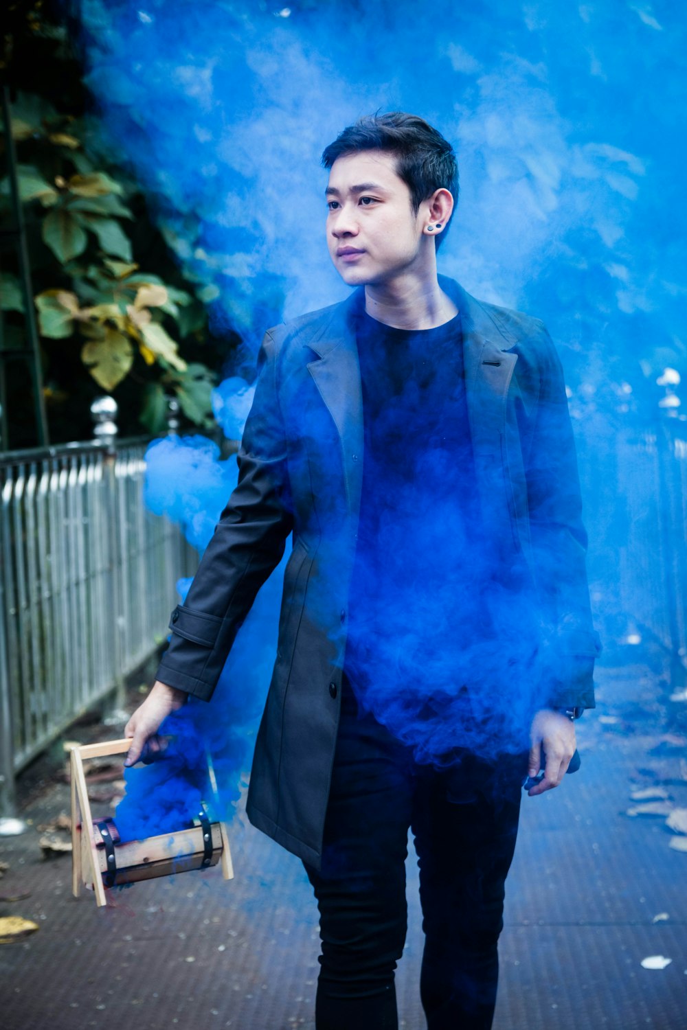 man holding box with blue smoke