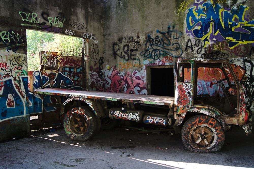 red and brown flatbed truck parked inside concrete building during daytime