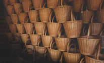 Stack of neatly arranged rattan baskets ready for shipping.