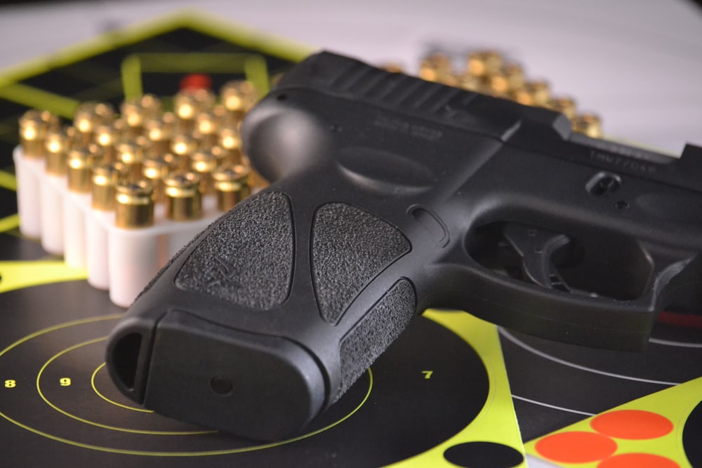 black pistol beside bullets