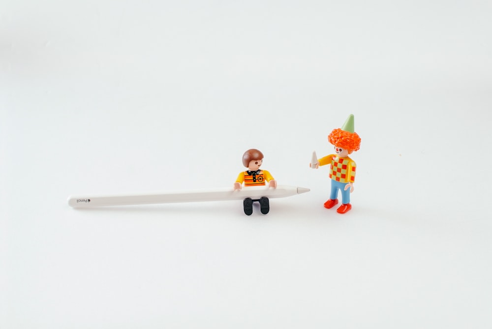 two Lego toys and Apple Pen