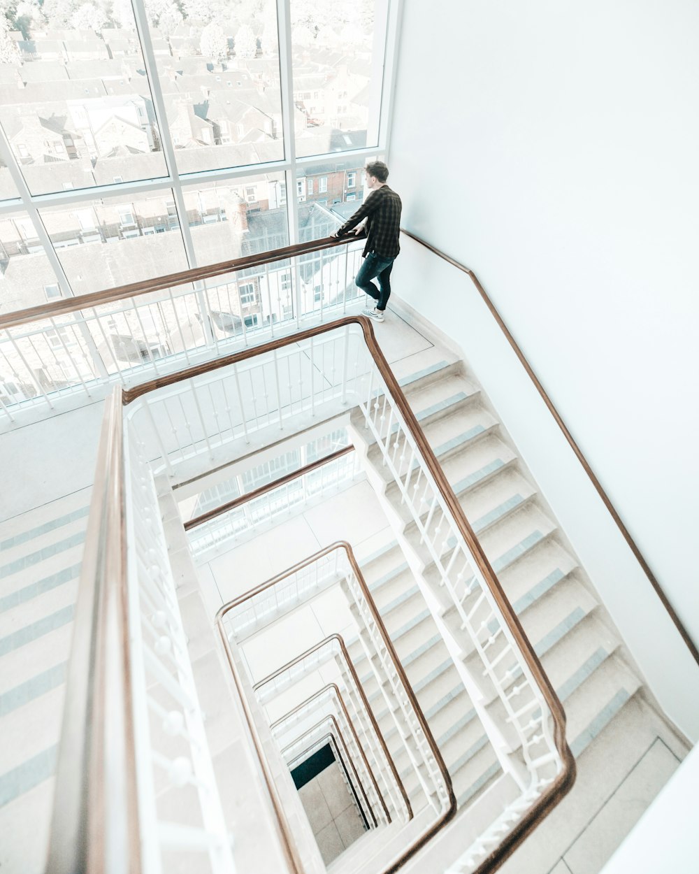 man standing near stairs inside building