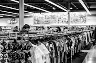grayscale photography of people inside a clothing shop