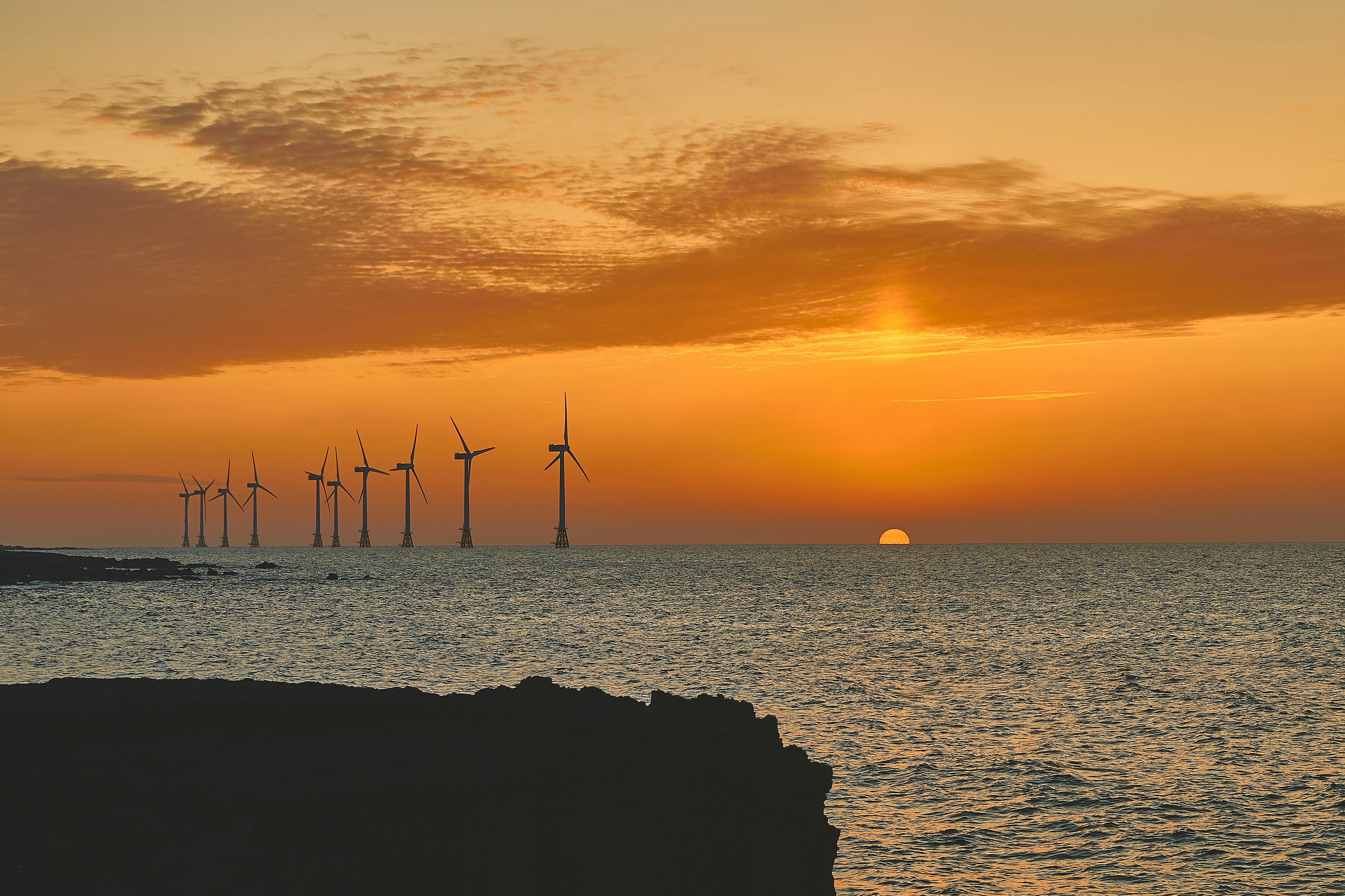silhouette of wind turbines during golden hour, Eveningfall 