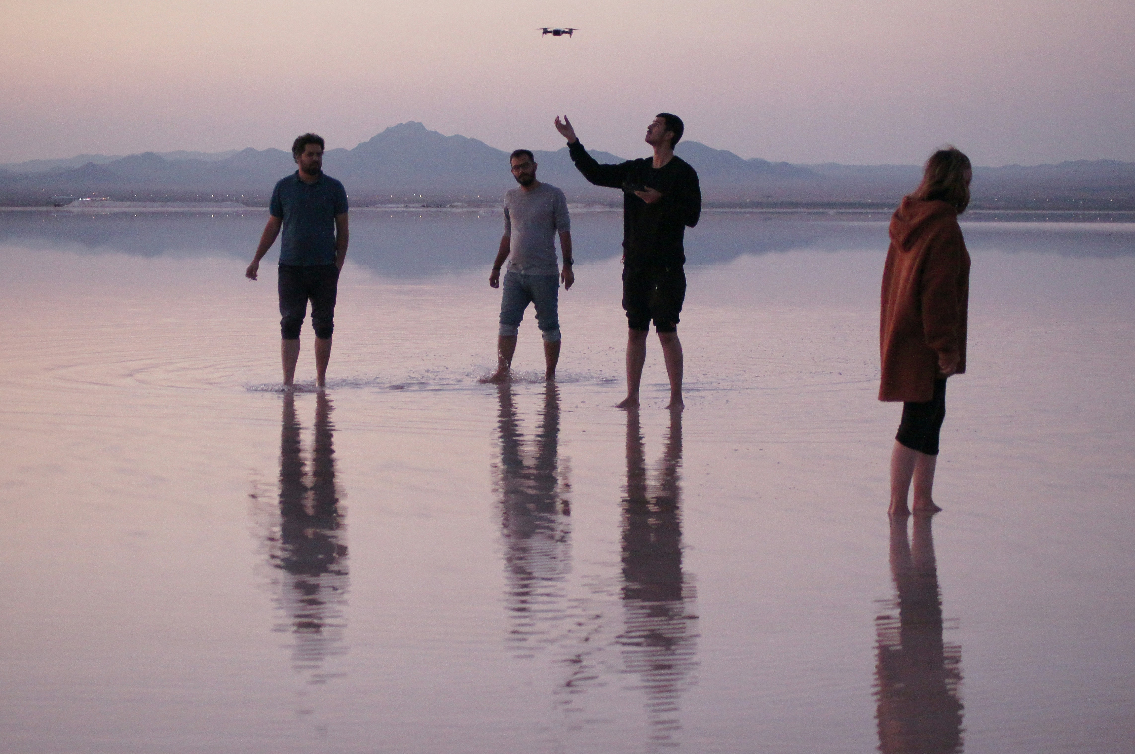 four people standing on wet ground, Biggest natural mirror in Iran.</p><p>