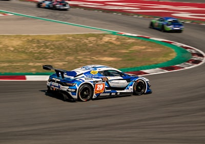 white and blue racing car renault zoom background