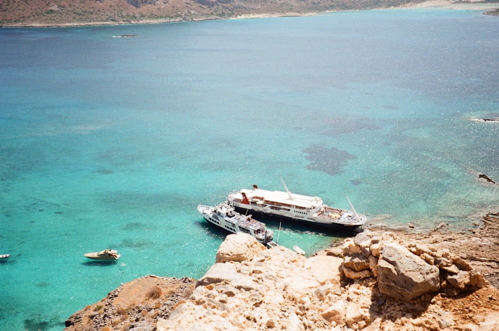 white motorboat on calm sea water during daytime