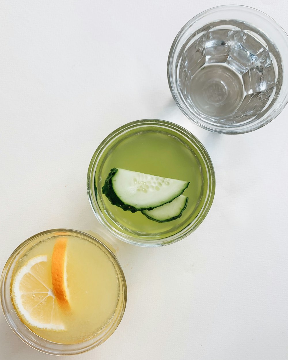 a couple of glasses filled with drinks on top of a table