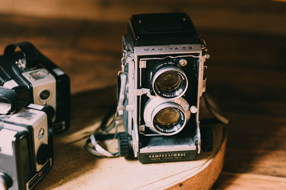 black and gray camera on brown table