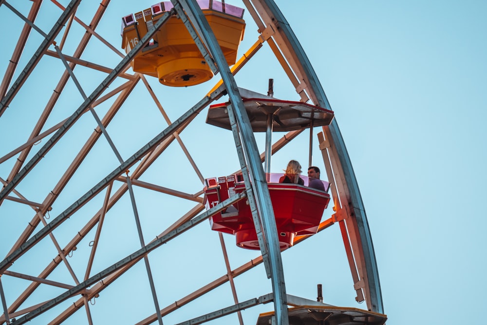 people riding ferris wheel during daytime