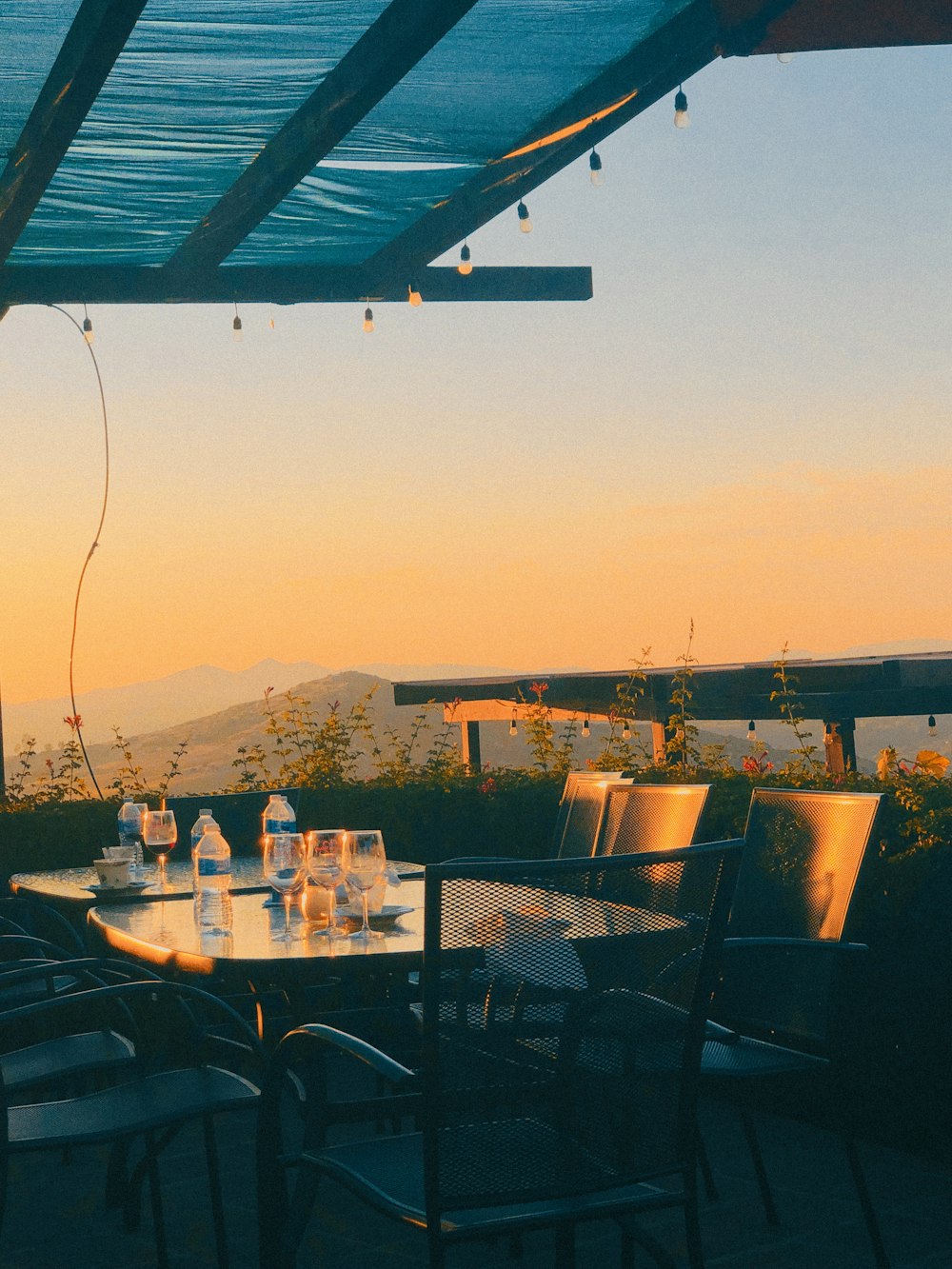 outdoor dining set with bottled water on top viewing mountain