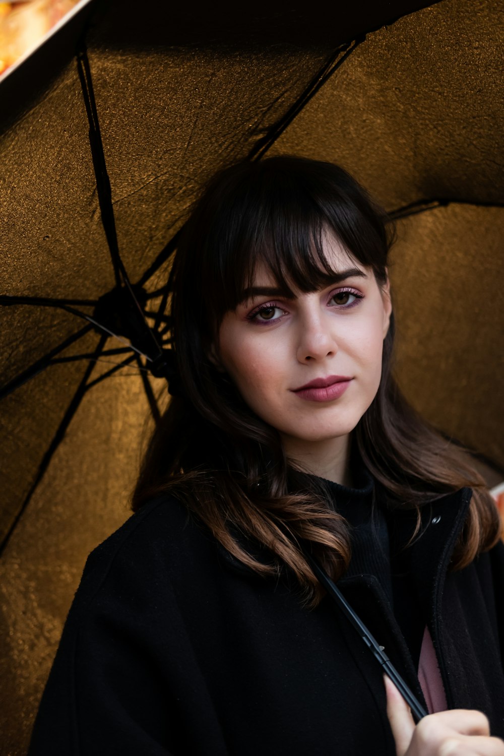 woman holding brown umbrella