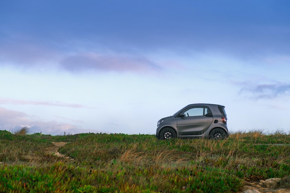 gray smart car on grass field