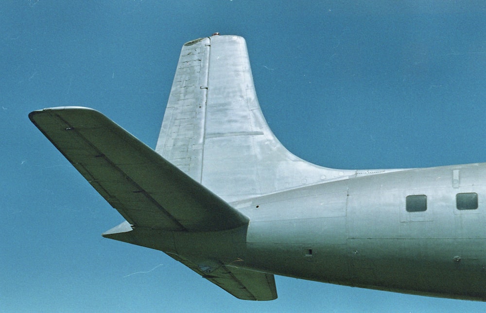 a large airplane flying through a blue sky