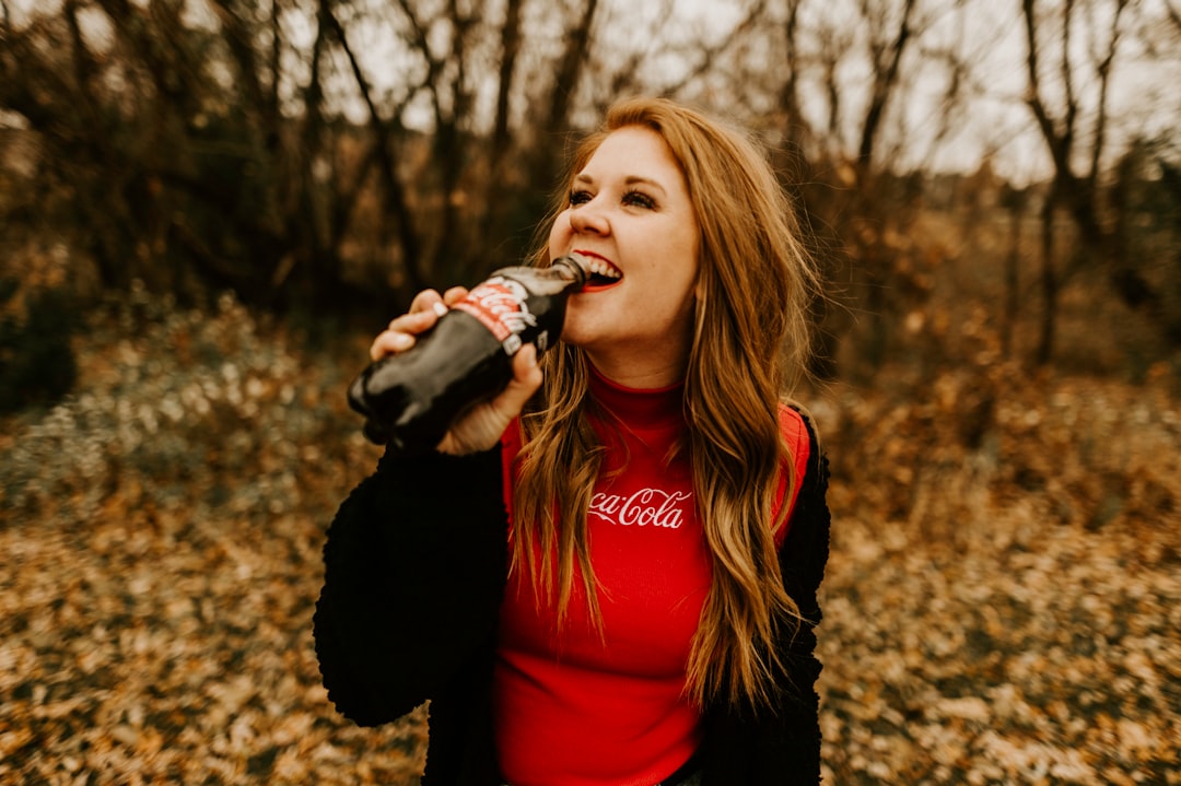 woman drinking Coca Cola bottle
