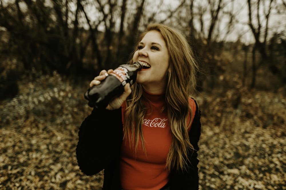 woman drinking Coca Cola bottle