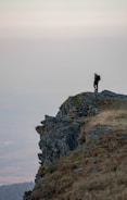 man standing on cliff edge