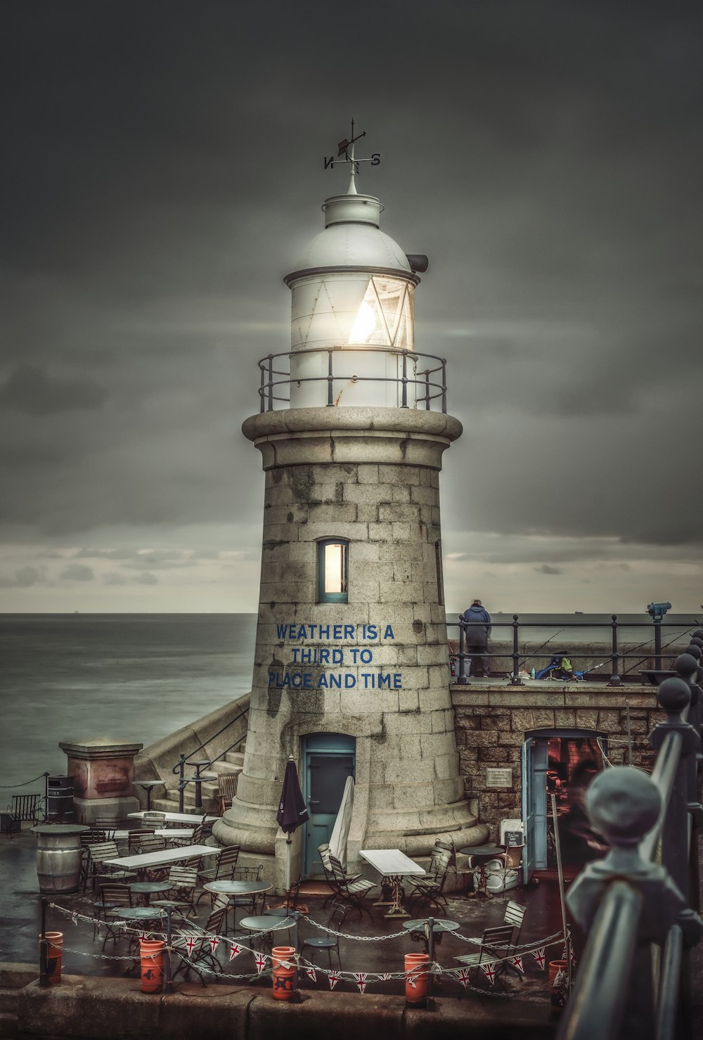 white and black lighthouse viewing sea