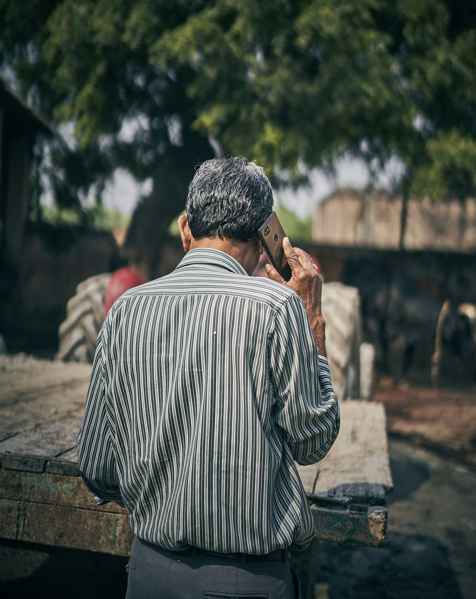 Sony a7 III sample photo. Man holding smartphone standing photography