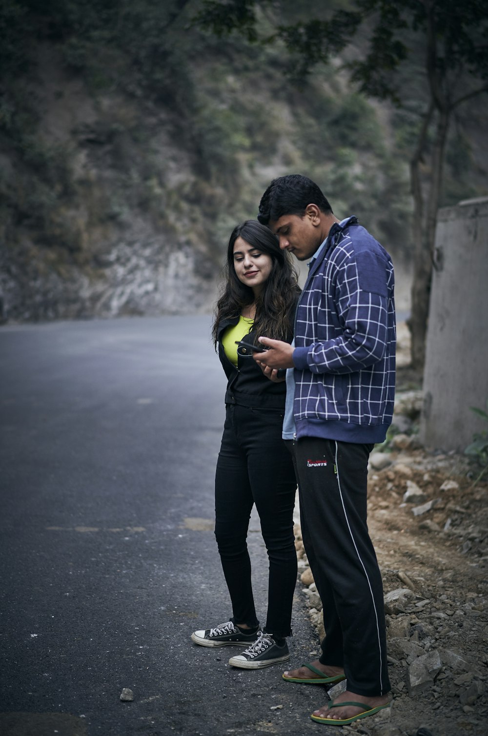 woman in black jacket and man in white and blue jacket