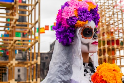 person wearing flowers near scaffolding day of the dead teams background