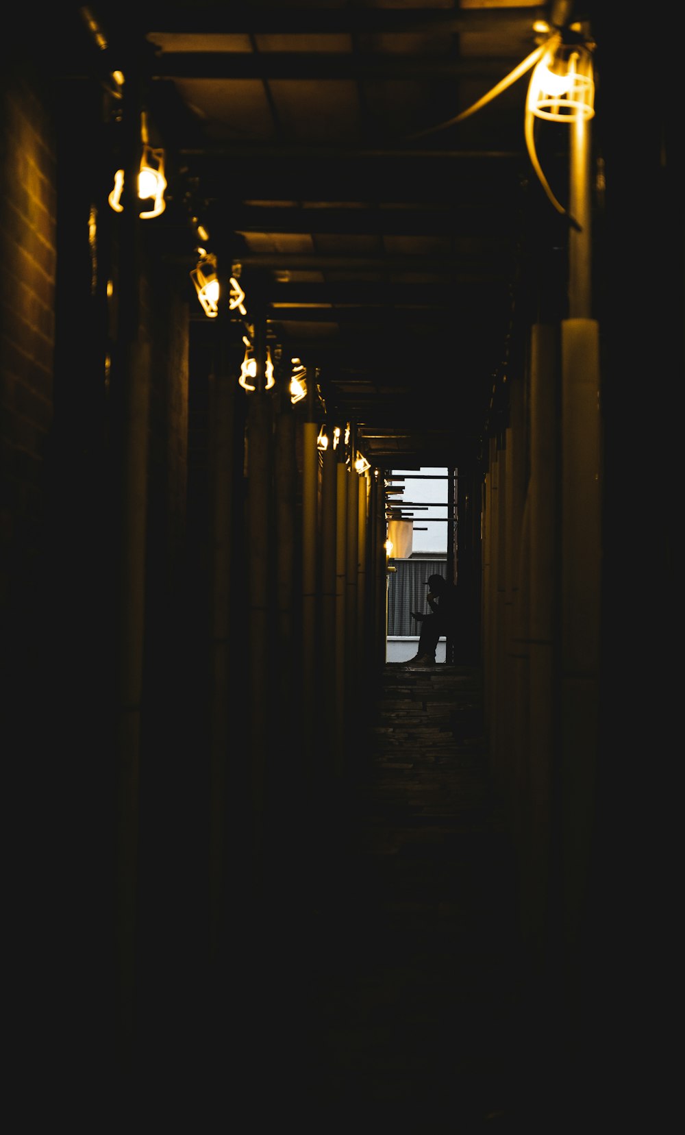 silhouette of person at the end of the hallway