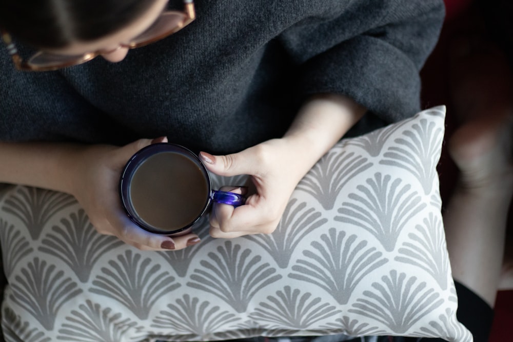 woman holding a mug of drink