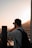 A traveler capturing memories with a beautiful sunset backdrop.