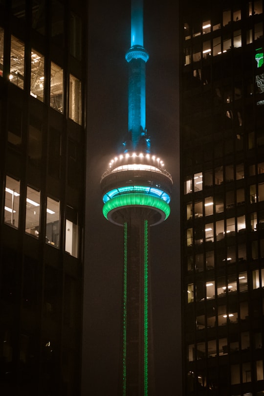 lighted blue and green tower during nighttime in HTO Park Canada