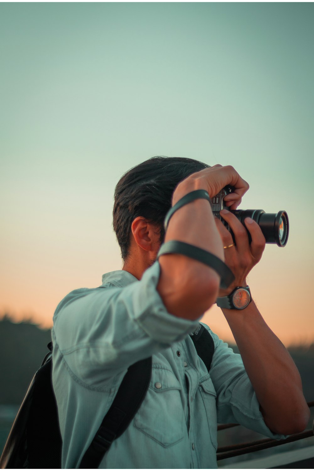 man taking photo using DSLR camera