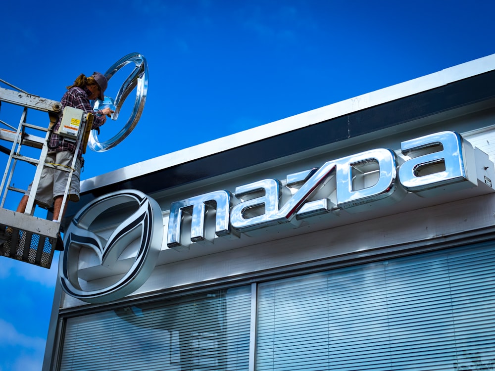 grey metal Mazda signage