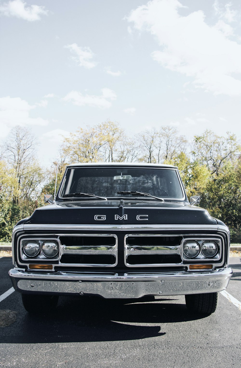 parked black and gray GMC vehicle during daytime