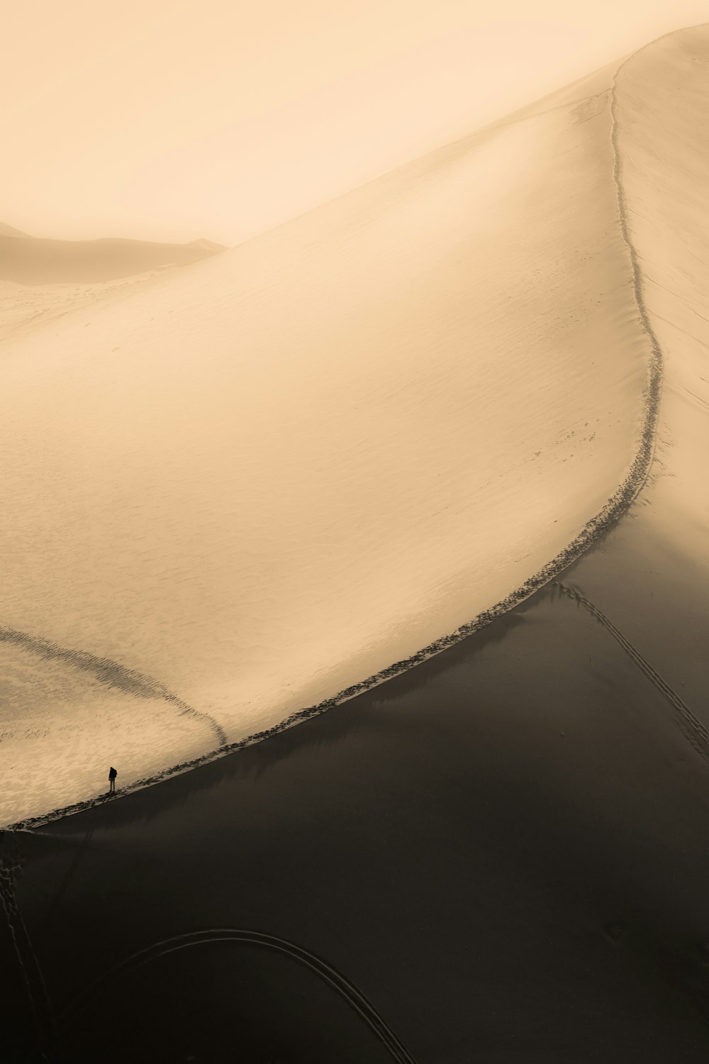 a lone person standing in the middle of a desert